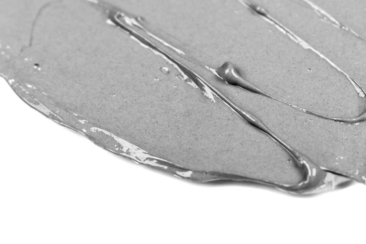 black-clay-smudged-gray-smear-of-korean-bubble-mask-on-white-background-isolated-acne-treatment-cosmetology-dermatology-beauty-product-skin-care-organic-cosmetics-closeup