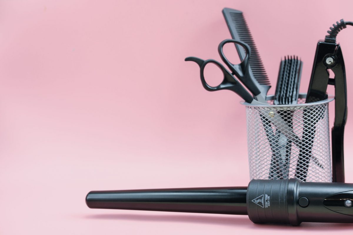 hair-stylist-tools-in-a-basket-scissors-brush-comb-curling-iron