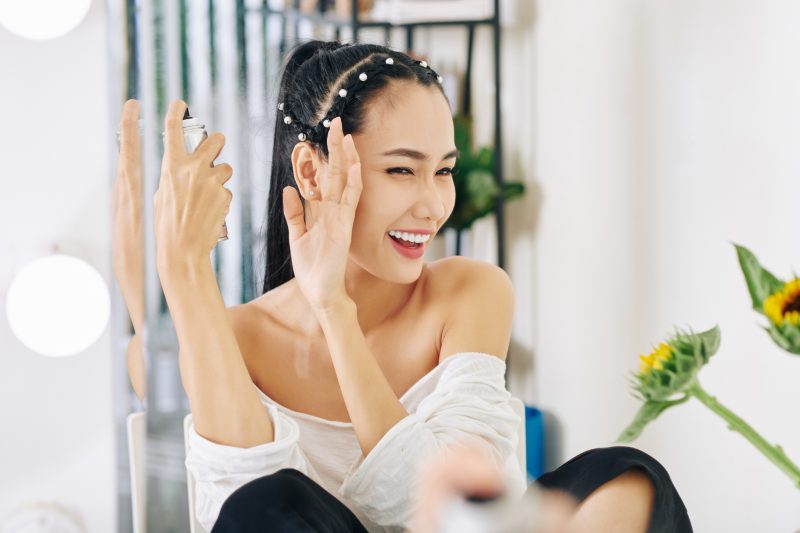 woman-applying-hair-spray