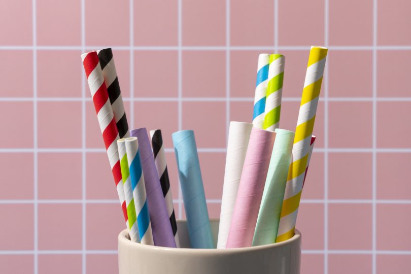 many-paper-drinking-straws-on-pink-squares-background