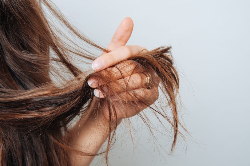 girl-holding-her-hair-in-her-hand-hair-care-concept-shampoo-haircut-needed