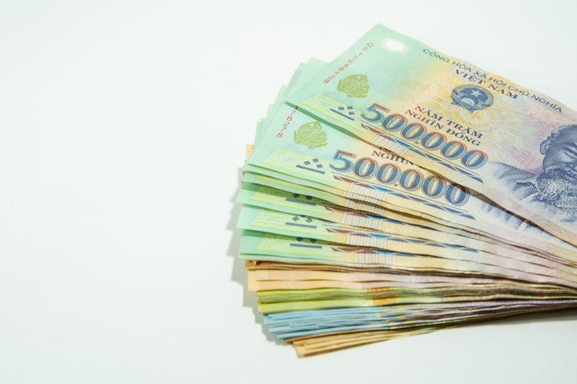 money-in-vietnam-on-hand-socialist-republic-of-vietnam-dong-vnd-pay-exchange-money-isolated-on-white-background