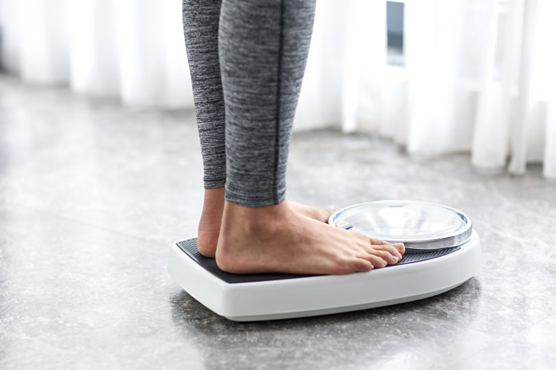 young-healthy-girl-on-home-scales