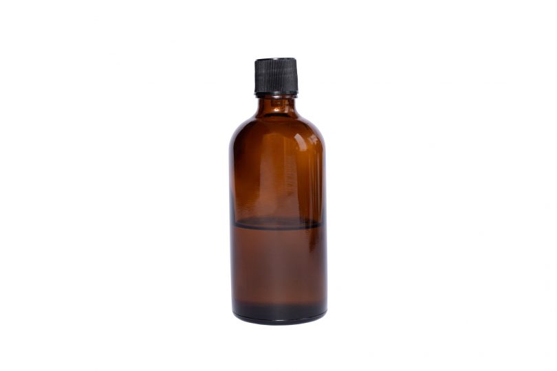 medical-brown-glass-oil-jar-with-black-lid-on-white-isolated-background