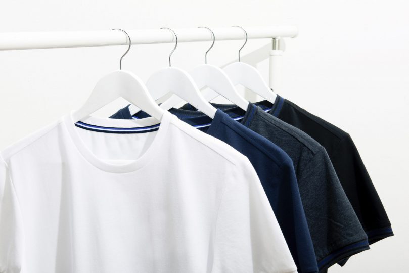 t-shirts-hanging-stack-on-white-rackclose-up