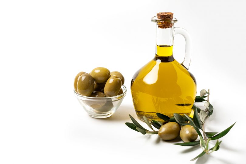 fresh-extra-virgin-olive-oil-in-a-bottle-green-olives-and-olive-tree-branches