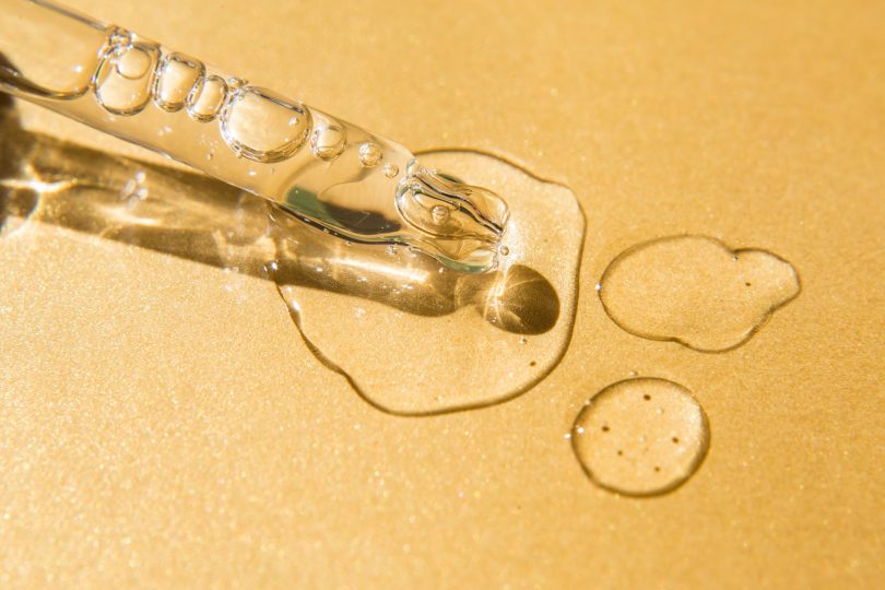 liquid-gel-and-serum-drops-nearby-pipette-on-glitter-yellow-background-beauty-product-with-peptides-ceramides-hyaluron-acid-flat-lay-top-view