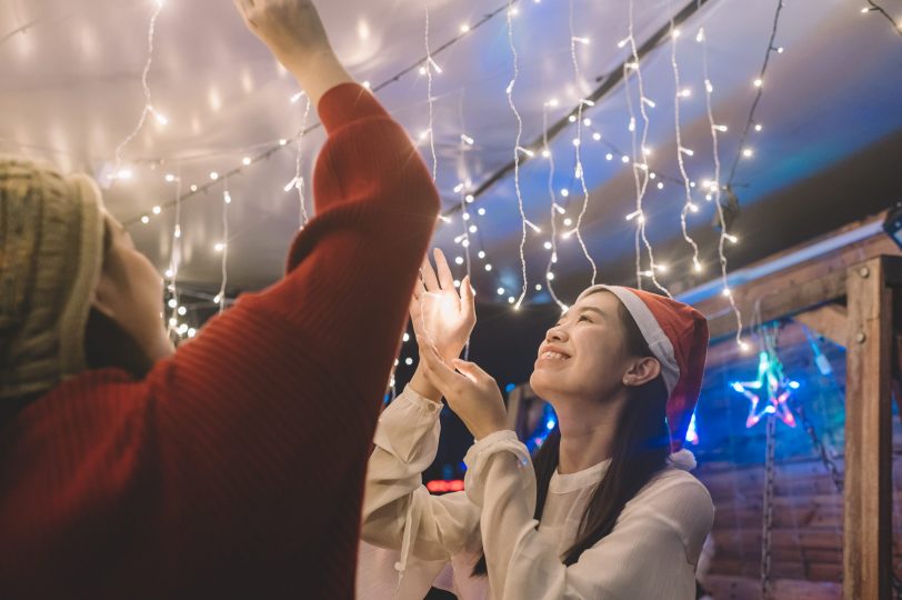 2-asian-chinese-young-girl-installing-christmas-string-light-for-the-party