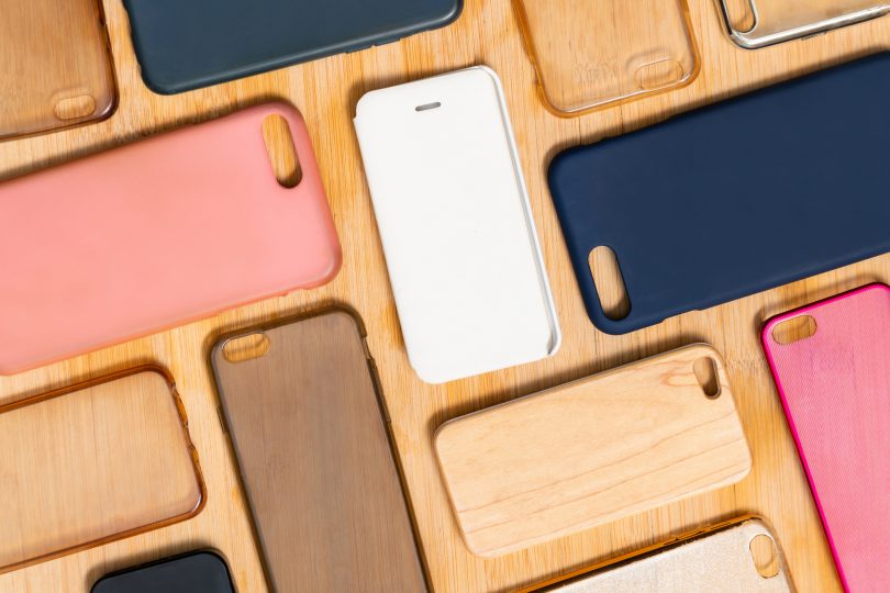 pile-of-multicolored-plastic-back-covers-for-mobile-phone-choice-of-smart-phone-protector-accessories-on-wooden-background-a-lot-of-silicone-phone-backs-or-skins-next-to-each-other-pattern