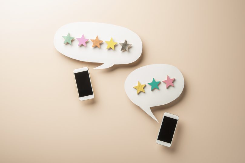 wooden-five-star-shape-with-chat-bubble-and-smart-phone