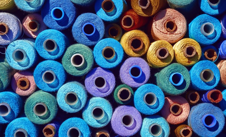 composition-of-sewing-spools-with-colorful-vibrant-threads-from-above
