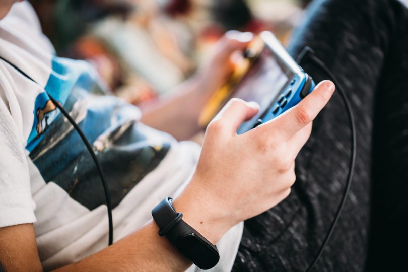 close-up-of-boy-hands-with-a-smart-watch-playing-videogames