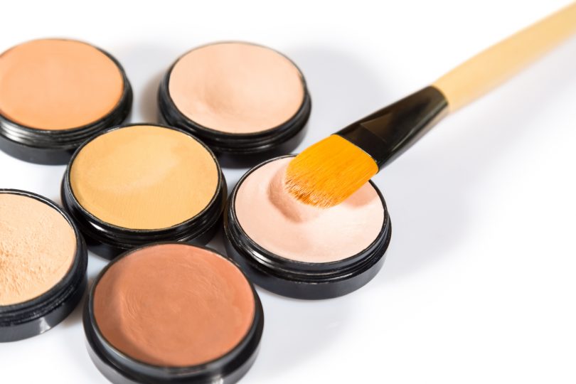 cosmetics-with-brushes-on-white-background