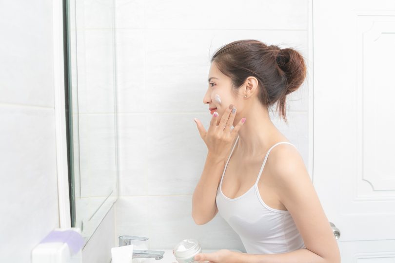 close-up-asian-beautiful-woman-applying-face-cream