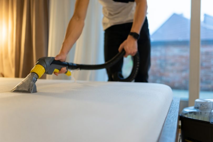 mattress-cleaning-process-man-cleans-bed-from-dirt-and-bacteria