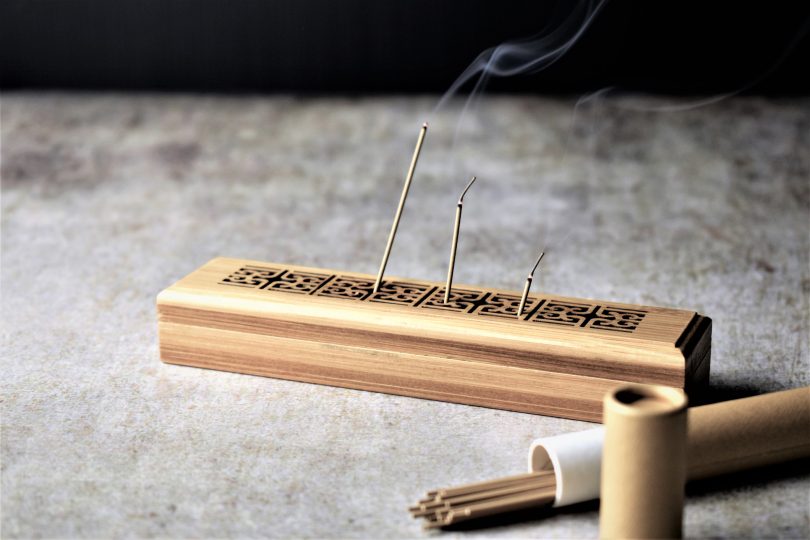 incense-sticks-and-incense-holder-on-a-rustic-background