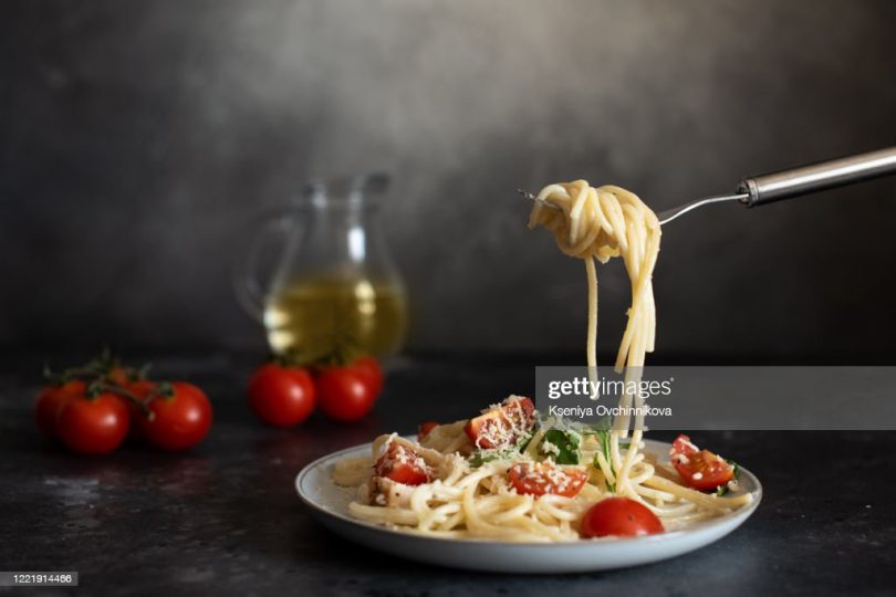 spaghetti-with-amatriciana-sauce-in-the-dish-on-the-wooden-table