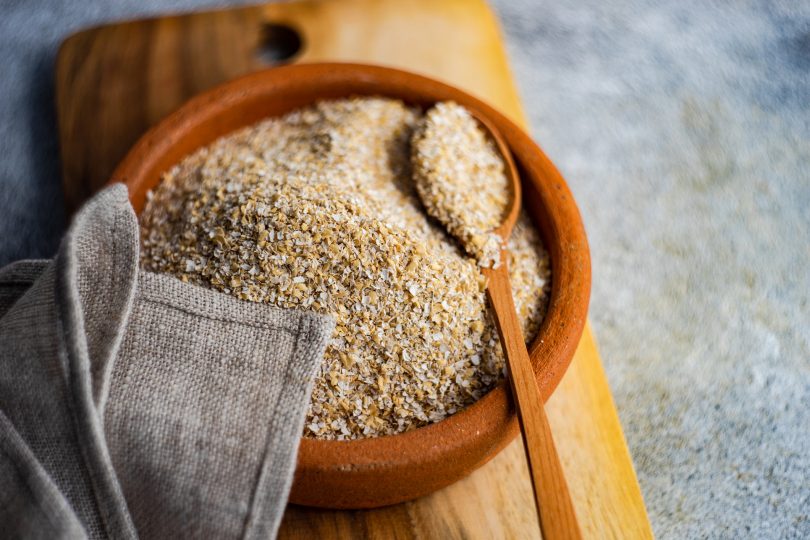 overhead-view-of-a-bowl-of-milled-oatmeal-bran-and-a-napkin